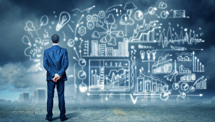 Back view image of young businessman standing against business sketch